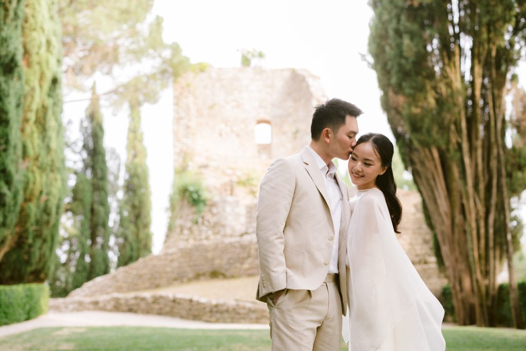 Elegant engagement couple sharing an intimate moment during a romantic session in Tuscany.